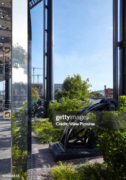 View looking between the columns with Industrial guide rail wheels from the gas holder. Gasholder No. 8 Park, London, United Kingdom. Architect: Bell...