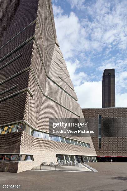 Early morning view of the Switch House with strong abstract shadow with the Tate chimney in the background. SWITCH HOUSE AT TATE MODERN, London,...