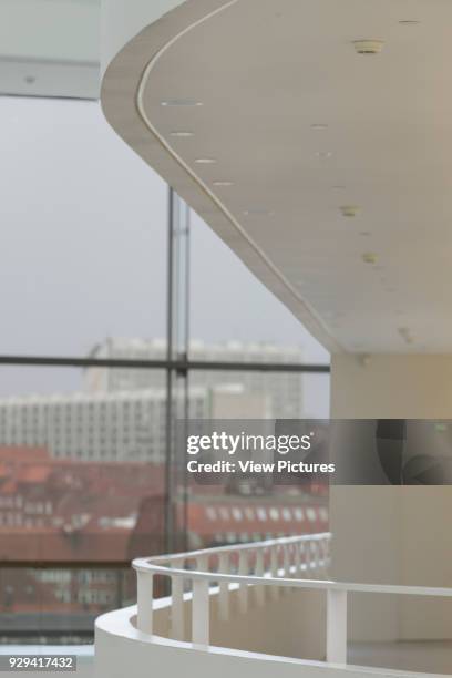 Detail of balcony in atrium, with city beyond. ARoS Aarhus Kunstmuseum, Aarhus, Denmark. Architect: schmidt hammer lassen, 2004.