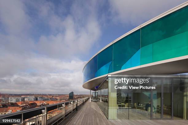 Your Rainbow Panorama' circular aerial walkway with cityscape beyond, roof pavilion and timber-floored rooftop terrace. ARoS Aarhus Kunstmuseum,...