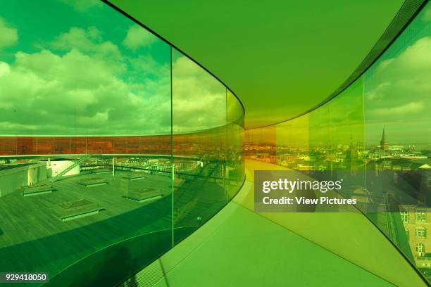 Interior of 'Your Rainbow Panorama' circular aerial walkway with cityscape beyond. ARoS Aarhus Kunstmuseum, Aarhus, Denmark. Architect: schmidt...
