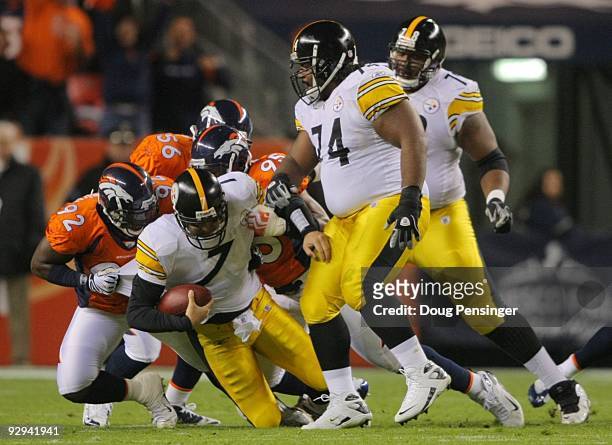 Ben Roethlisberger of the Pittsburgh Steelers gets sacked by Elvis Dumervil and Darrell Reid of the Denver Broncos at Invesco Field at Mile High on...