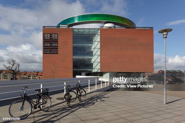 Main entrance with 'Your Rainbow Panorama' aerial walkway on roof, bicycles with railings in foreground. ARoS Aarhus Kunstmuseum, Aarhus, Denmark....