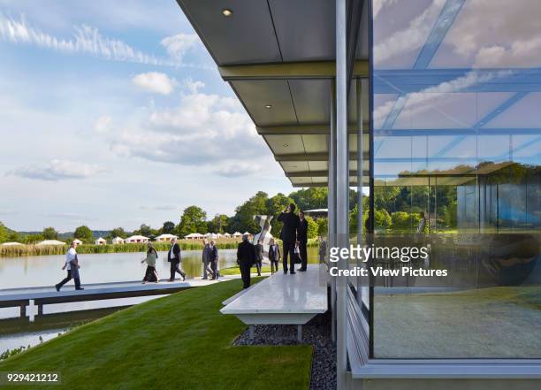 Glass pavilion with visitors during event. Island Pavilion and Footbridge, High Wycombe, United Kingdom. Architect: Snell Associates, 2014.
