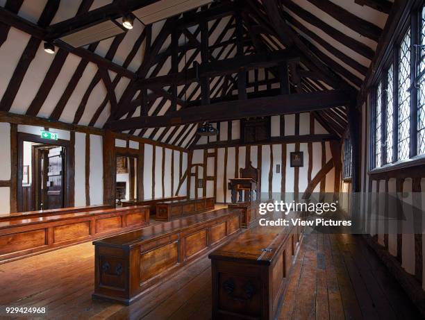 Classroom with teacher's desk and wooden chests. Shakespeare's Schoolroom, Stratford-upon-Avon, United Kingdom. Architect: Wright & Wright Architects...