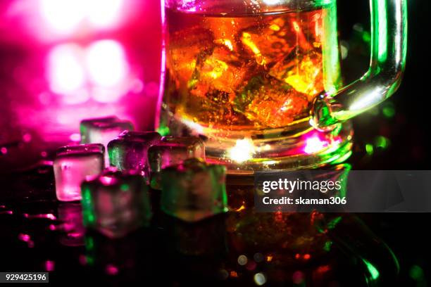 selective focus pure whisky with ice cube inside whisky glass on wet background - whiskey tasting stock pictures, royalty-free photos & images