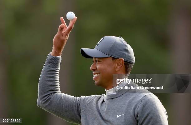 Tiger Woods catches a ball on the 17th hole during the first round of the Valspar Championship at Innisbrook Resort Copperhead course on March 8,...