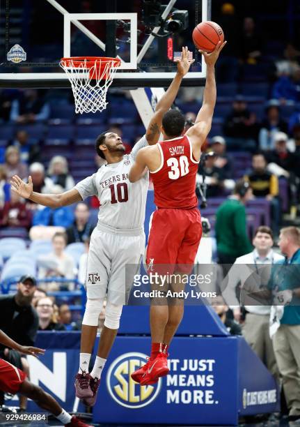 Tonny Trocha-Morelos of the Texas A&M Aggies defends the shot of Galin Smith of the Alabama Crimson Tide during the second round of the 2018 SEC...