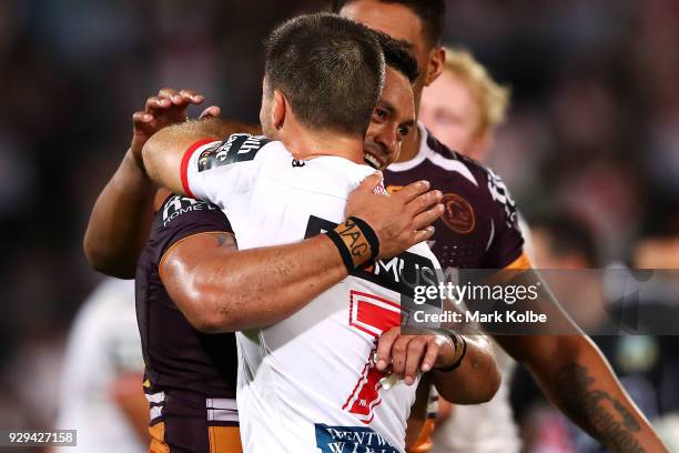 Alex Glenn of the Broncos and Ben Hunt of the Dragons embrace after the match during the round one NRL match between the St George Illawarra Dragons...