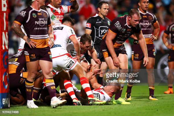 Jack De Belin of the Dragons celebrates with his team mates after scoring a try during the round one NRL match between the St George Illawarra...
