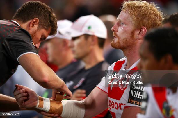 James Graham of the Dragons watches on from the bench as he has his arm strapped during the round one NRL match between the St George Illawarra...