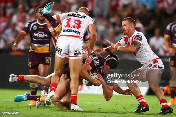 Corey Oates of the Broncos is tackled during the round one NRL match between the St George Illawarra Dragons and the Brisbane Broncos at UOW Jubilee...