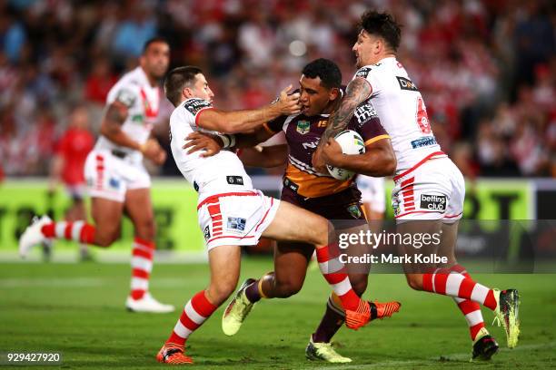 Tevita Pangai of the Broncos is tackled during the round one NRL match between the St George Illawarra Dragons and the Brisbane Broncos at UOW...