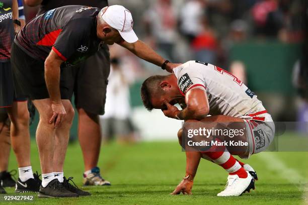 Paul Vaughan of the Dragons receives attention from the trainer during the round one NRL match between the St George Illawarra Dragons and the...