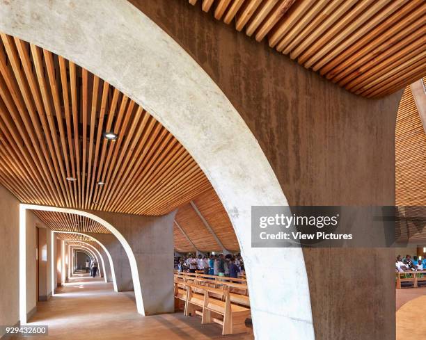 Cathedral side aisle. Sacred Heart Cathedral Of The Catholic Diocese Of Kericho, Kericho, Kenya. Architect: John McAslan & Partners, 2016.