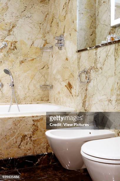Westbury Hotel, Mayfair, London, United Kingdom. Architect: Dorothy Draper & Co., 2014. Bathroom and toilet with marble surround.