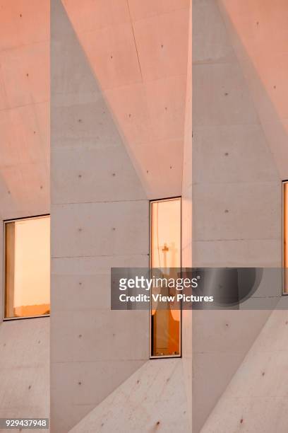 Window with reflection and concrete facet. Palacio da Justicia de Gouveia, Gouveia, Portugal. Architect: Barbosa & Guimaraes, 2011.