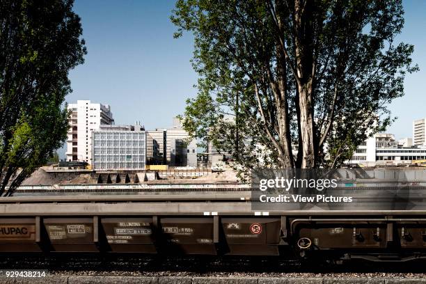 View across river Rhine and railroad track towards the Novartis Campus. Novartis Campus Virchow 6, Basel, Switzerland. Architect: Alvaro Siza, 2012.