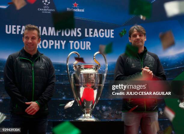 Former football players, Italian Alessandro Del Piero and Spanish Fernando Morientes pose with the UEFA Champions League trophy, during a press...