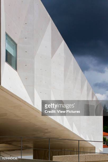 Perspective along faceted concrete wall. Palacio da Justicia de Gouveia, Gouveia, Portugal. Architect: Barbosa & Guimaraes, 2011.