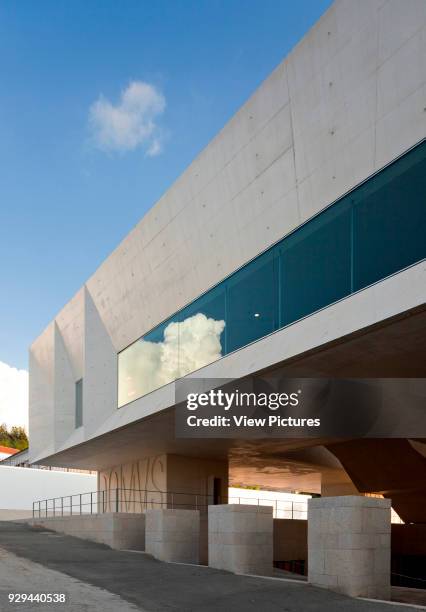 Oblong window with reflection on upper floor facade. Palacio da Justicia de Gouveia, Gouveia, Portugal. Architect: Barbosa & Guimaraes, 2011.