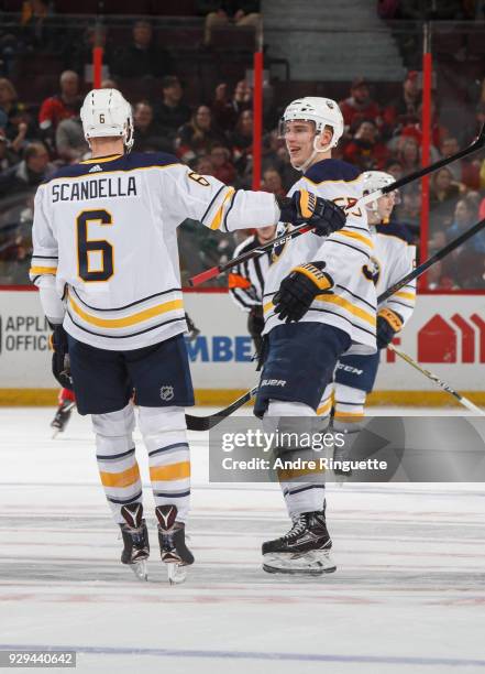 Marco Scandella of the Buffalo Sabres celebrates his first period goal against the Ottawa Senators with teammate Rasmus Ristolainen at Canadian Tire...