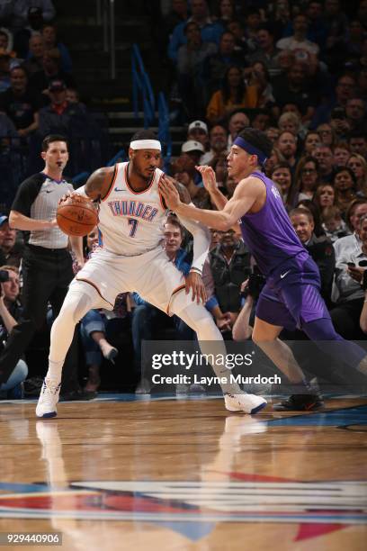 Carmelo Anthony of the Oklahoma City Thunder handles the ball against Devin Booker of the Phoenix Suns during the game between the two teams on March...