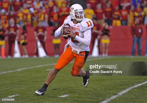 Quarterback Zac Robinson of the Oklahoma State Cowboys rolls out during play against the Iowa State Cyclones in the second half of play at Jack Trice...