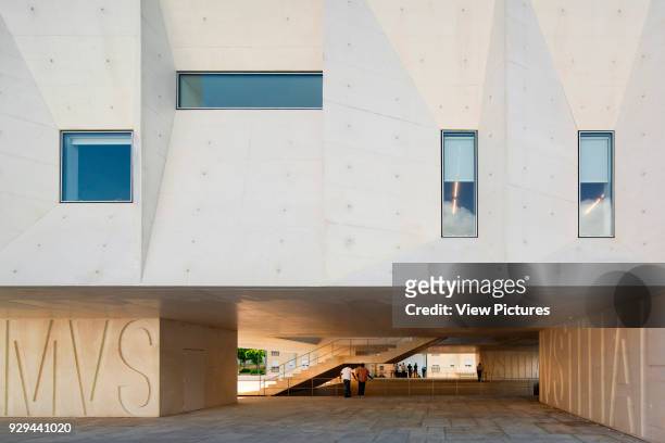 Detailed front elevation of faceted concrete with windows. Palacio da Justicia de Gouveia, Gouveia, Portugal. Architect: Barbosa & Guimaraes, 2011.