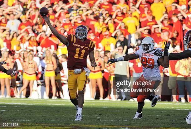 Quarterback Jerome Tiller of the Iowa State Cyclones passes under pressure from defensive end Richetti Jones of the Oklahoma State Cowboys in the...