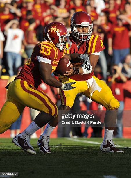 Quarterback Austen Arnaud of the Iowa State Cyclones hands off to running back Alexander Robinson during the game against the Oklahoma State Cowboys...