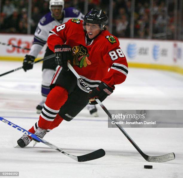 Patrick Kane of the Chicago Blackhawks brings the puck up the ice past Wayne Simmonds of the Los Angeles Kings at the United Center on November 9,...