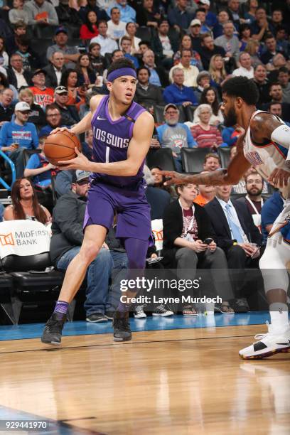 Devin Booker of the Phoenix Suns handles the ball during the game against the Oklahoma City Thunder on March 8, 2018 at Chesapeake Energy Arena in...