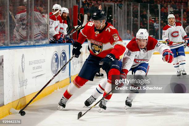 Maxim Mamin of the Florida Panthers skates with the puck against Mike Reilly of the Montreal Canadiens at the BB&T Center on March 8, 2018 in...