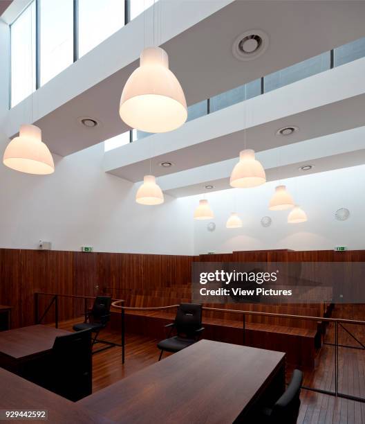 Courtroom clad in dark timber with rooflights. Palacio da Justicia de Gouveia, Gouveia, Portugal. Architect: Barbosa & Guimaraes, 2011.