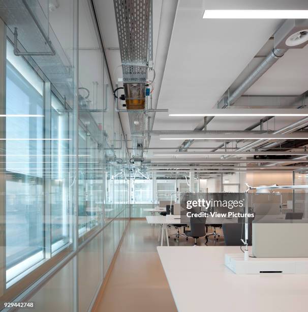 Open plan office with glass wall. Novartis Campus Virchow 6, Basel, Switzerland. Architect: Alvaro Siza, 2012.