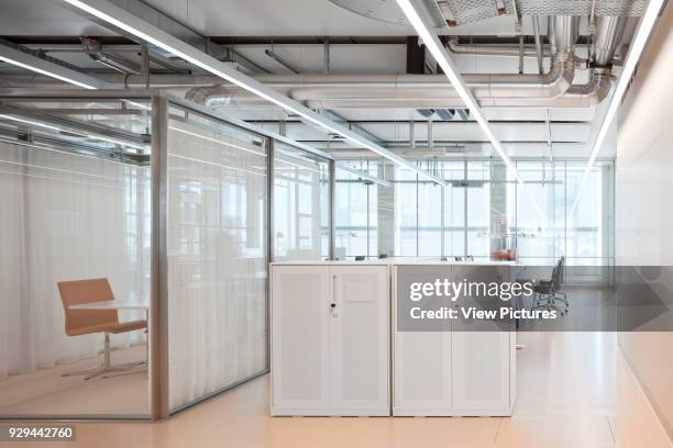 Office space with glass partitioning. Novartis Campus Virchow 6, Basel, Switzerland. Architect: Alvaro Siza, 2012.