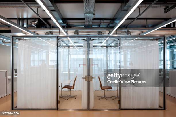 Office space with glass partitioning. Novartis Campus Virchow 6, Basel, Switzerland. Architect: Alvaro Siza, 2012.