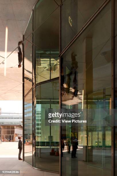 View along glazed and reflective entrance facade. Novartis Campus Virchow 6, Basel, Switzerland. Architect: Alvaro Siza, 2012.