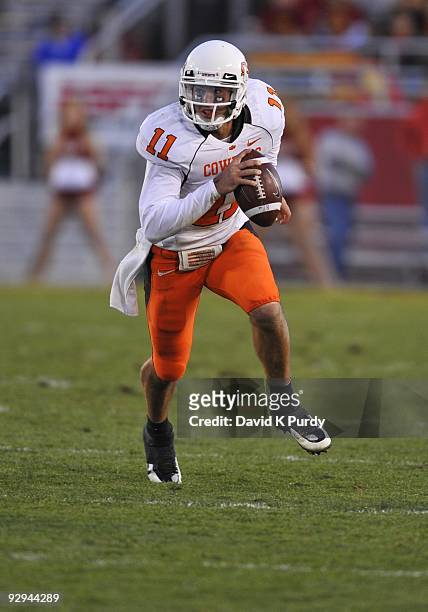 Quarterback Zac Robinson of the Oklahoma State Cowboys scrambles during play against the Iowa State Cyclones in the second half of play at Jack Trice...