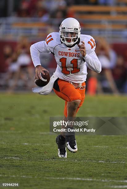 Quarterback Zac Robinson of the Oklahoma State Cowboys scrambles during play against the Iowa State Cyclones in the second half of play at Jack Trice...