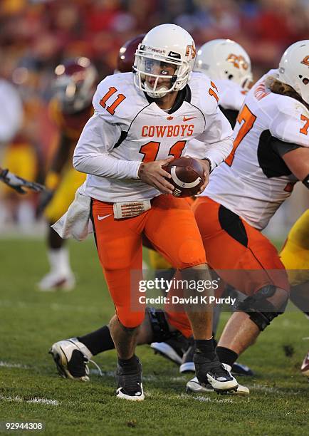 Quarterback Zac Robinson of the Oklahoma State Cowboys drops back during play against the Iowa State Cyclones in the second half of play at Jack...