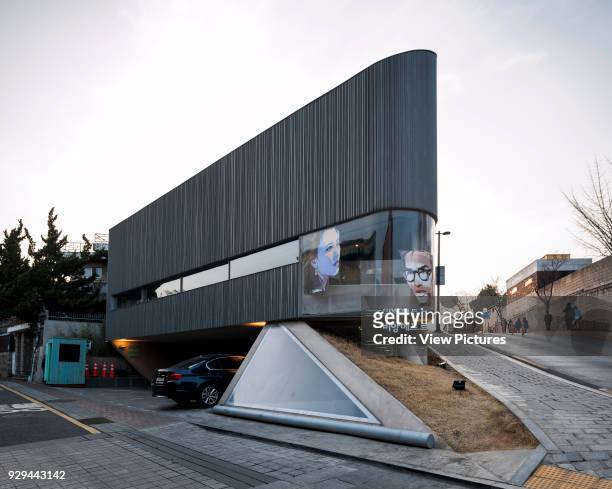 Elevation from street with triangular skylight. Songwon Art Center / Bien-etre Restaurant, Seoul, Korea, South. Architect: Mass Studies, 2012.
