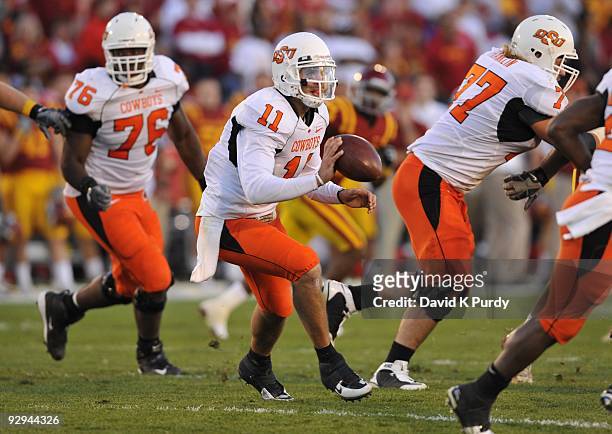 Quarterback Zac Robinson of the Oklahoma State Cowboys pitches the ball during play against the Iowa State Cyclones in the second half of play at...