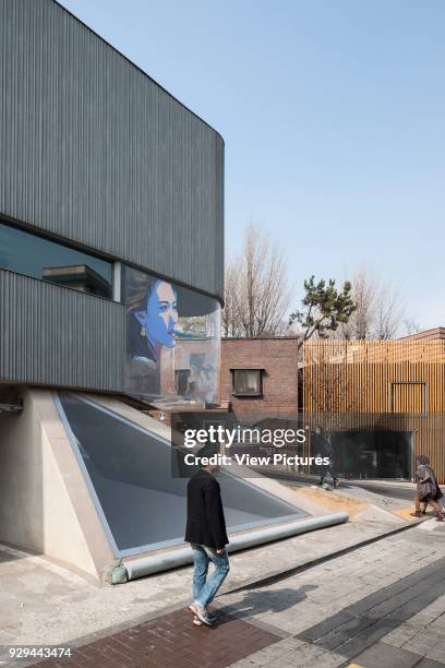 Partial view of facade with triangular skylight. Songwon Art Center / Bien-etre Restaurant, Seoul, Korea, South. Architect: Mass Studies, 2012.