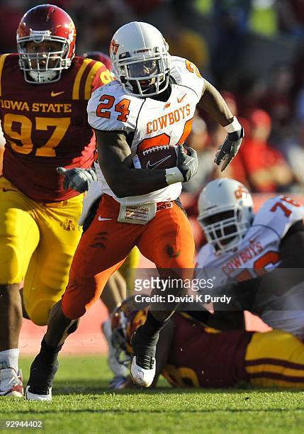 Running back Kendall Hunter of the Oklahoma State Cowboys rushes for yards up the middle past defensive tackle Stephen Ruempolhamer of the Iowa State...
