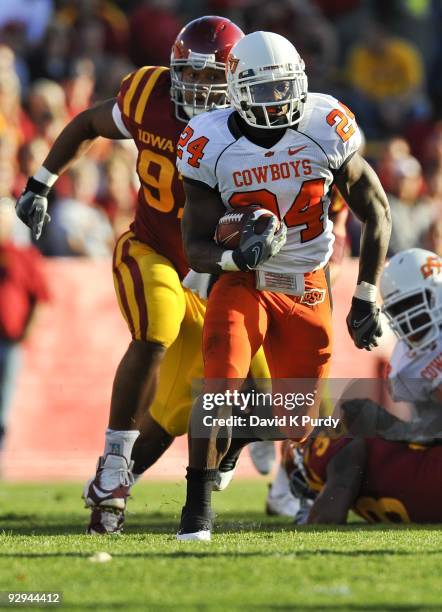 Running back Kendall Hunter of the Oklahoma State Cowboys rushes for yards up the middle past defensive tackle Stephen Ruempolhamer of the Iowa State...