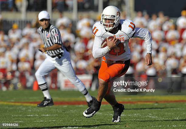 Quarterback Zac Robinson of the Oklahoma State Cowboys scrambles for yards in the first half of play during the game against the Iowa State Cyclones...