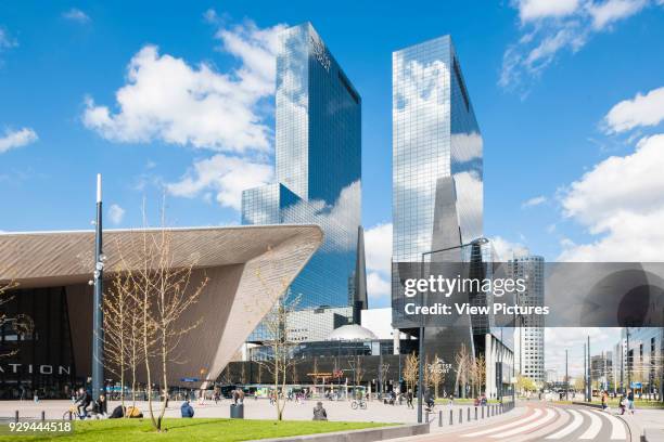 Long distance main entrance angular view od metal clad canopy, high rise buildings and public plaza. Centraal Station, Rotterdam, Netherlands....