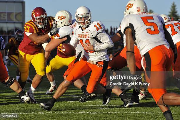 Quarterback Zac Robinson of the Oklahoma State Cowboys drops back during the game against the Iowa State Cyclones at Jack Trice Stadium on November...